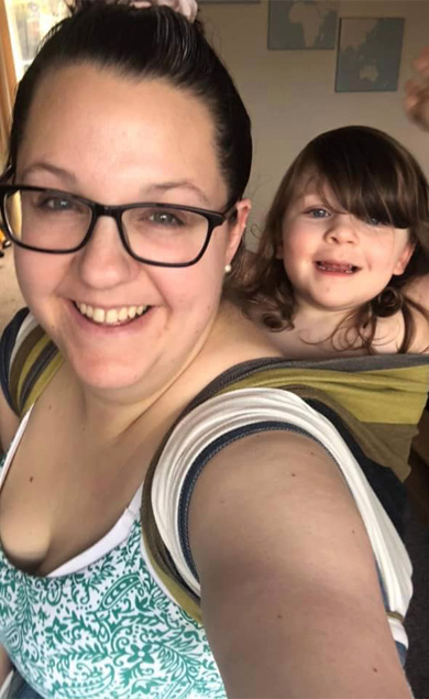 Parenting Support Collective in Manchester and Greater Manchester Boroughs smiling mother and baby in back sling taking a selfie