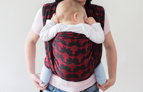 Parenting Support Collective in Manchester and Greater Manchester Boroughs mother and baby in funky patterned red and black sling